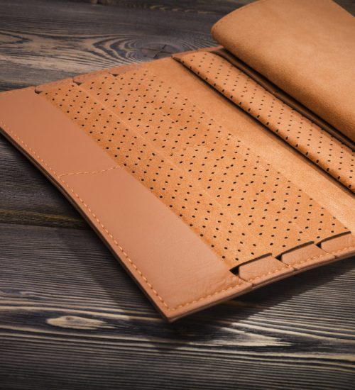 New leather wallet on rustic wood background